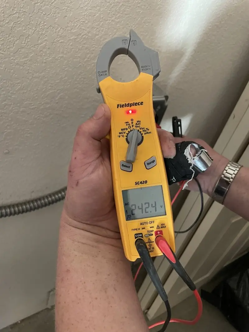 Voltage testing with clamp meter during Electrical Installation Services in Madisonville